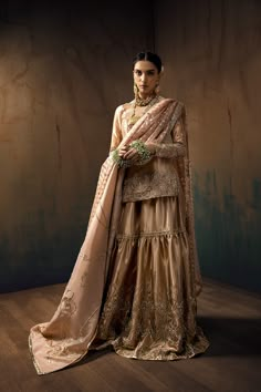 a woman in a dress and jewelry standing on a wooden floor