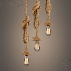 three light bulbs are hanging from rope