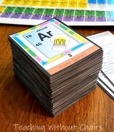 a stack of cards sitting on top of a table next to a pile of papers