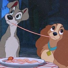 lady and the tramp looking at each other in front of a plate of spaghetti