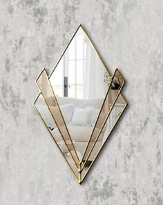 a mirror that is on the wall in front of a couch with pillows and blankets