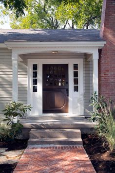 the front door of a house with steps leading up to it