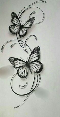 two butterflies are flying in the air with their wings spread out and one is on top of