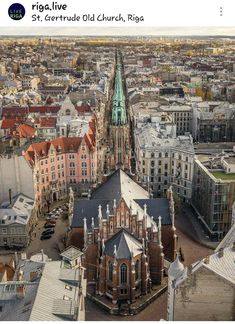 an aerial view of a city with tall buildings and steeple spires in the background