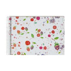 a spiral notebook with flowers and berries on it, in front of a white background