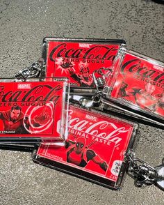 three key chains with coca cola images on them