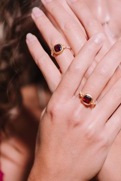 This handcrafted ring features a deep red garnet, elegantly set in a rich gold bezel, beautifully contrasting with the slender silver band. The delicate gold accents on either side of the garnet add a playful touch, creating a more casual feel. This piece can easily be combined with a casual oufit or really be accentuated by combining it with a red or black cocktail dress. Sterling silver  Gold vermeil  Garnet  To properly care for your silver jewellery, there are a few important steps you shoul Gold Garnet Ring, Sustainable Accessories, Red Or Black, August Birthstone Jewelry, July Birthstone Jewelry, Garnet Ring, Black Cocktail, Handcrafted Rings, Pearl Jewellery Earrings