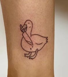 a duck with a knife in its beak tattoo on the leg