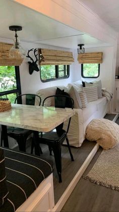 the interior of a mobile home with wood floors and white walls, windows, and furniture