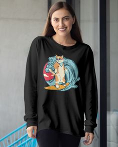 a woman wearing a black shirt with an image of a cat on the surfboard