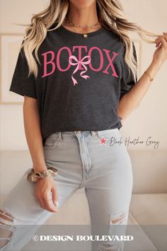 a woman wearing a boston t - shirt with pink lettering on the front and bottom