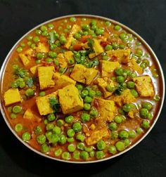 a bowl filled with peas and tofu