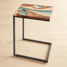 a wooden table sitting on top of a hard wood floor next to a metal frame