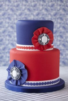 a red, white and blue cake with flowers on top