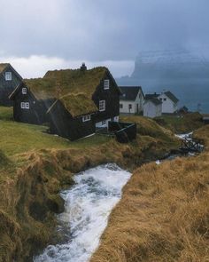 some houses with grass roofs and water running through them