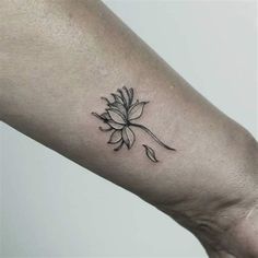 a black and white flower tattoo on the arm