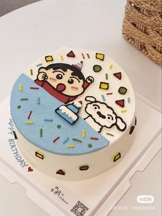 a birthday cake decorated with an image of a boy holding a teddy bear on it