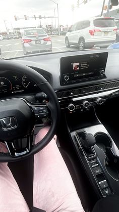 the interior of a car with dashboard, steering wheel and dash board showing various electronic devices