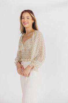 Nothing says summer like the Lemon Tart Smocked Top! This beautiful cropped blouse features a charming sweetheart neckline and knotted detail, plus its smocked bodice and bishop sleeves ensure maximum comfort while you're soaking up the sun. Pair with white denim for your favorite look of the season! FIT: Runs true to size. Cropped. MATERIAL: Self: 100% Polyester, Lining: 100% Polyester. GARMENT DETAILS: Lightweight floral print top, with sweetheart neckline and knotted detail bust. Features a smocked ribcage panel, with long bishop sleeves and elasticized shoulders. Lined. SIZE GUIDE: XS (0-2) / S (2-4) / M (6-8) / L (10-12) MODEL DETAILS: Mackenzie - Size S Heather - Size S Molly - Size XL Our Brunette Misses Model Our Blonde Misses Model Our Blonde Curve Model Bust 34" 34" 37" Waist 27. Summer Flowy Blouse With Smocked Bodice, Spring Brunch Blouse With Smocked Bodice, Beige Summer Blouse With Smocked Bodice, Spring Feminine Peasant Top With Smocked Bodice, Chic Smocked Crop Top For Brunch, Chic Smocked Bodice Crop Top For Brunch, Spring Blouse With Smocked Bodice For Brunch, Chic Flowy Smocked Top, Chic Flowy Smocked Top With Smocked Bodice