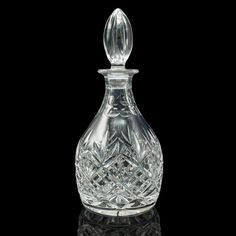 a crystal decanter on a black background