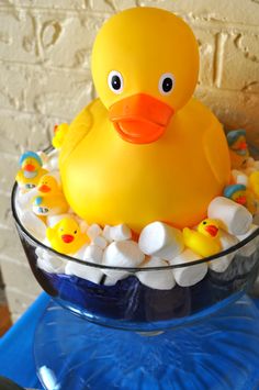 a yellow rubber duck in a bowl filled with marshmallows