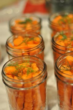 small jars filled with carrots sitting on top of a table