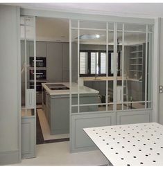 an empty kitchen with glass doors leading to the dining room