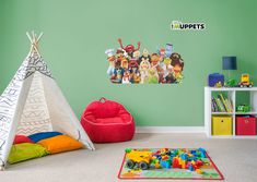 children's playroom with teepees, toys and wall decals on the walls