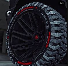 the tire and wheel of a vehicle with red lettering on it's rims