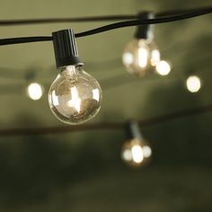 some light bulbs are hanging from a wire