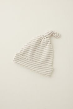 Driftwood Stripe: A warm flax stripe on a natural base. Top off your little one's coming-home outfit with our silky-soft TENCEL™ modal hat. The knotted + roll-up design can be tailored to fit from birth to 6 months and pairs perfectly with our sleepers and gowns. Adjustable Soft White Bonnet, Soft Adjustable White Bonnet, Cotton Hat, One Size Fits Most, Adjustable Soft Knit Cream Hat, Adjustable Cream Soft Hat, Adjustable Cream Soft Knit Hat, Adjustable Beige Cotton Bonnet, Adjustable Soft Cream Hat, Cream Soft Hat, One Size Fits Most