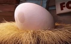 an egg is sitting on top of some hay