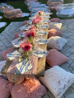 a long table with plates and flowers on it