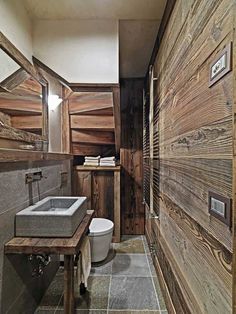 a bathroom with wooden walls and tile flooring