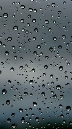 raindrops on the window with dark blue sky in the background