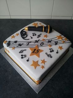 a sheet cake with musical notes and stars on it, sitting on top of a table