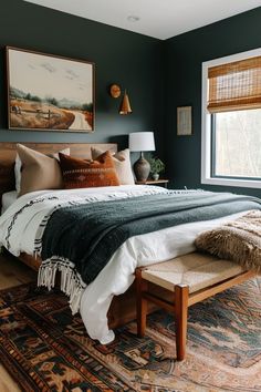 a bedroom with a large bed and two paintings on the wall