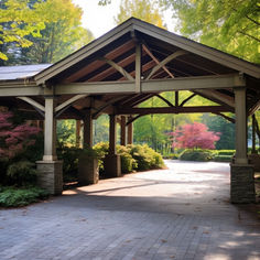 a covered walkway in the middle of a park with lots of trees and bushes around it