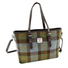 This luxury, stylish tote/shoulder bag is made from handwoven Harris Tweed wool exclusively woven in the Outer Hebridean islands off the West Coast of Scotland.  The bag is zippered and comes with adjustable faux leather handles as well as a removeable shoulder strap.  It is fully lined and includes two inside pockets. Weighing less than 2lb it measures 17" wide, 11.5" tall,  and gusseted base 15" x 5". The design is based on the McLeod of Harris (aka Hunting) plaid in muted colors of green and blue with a wide black overcheck.  The Harris Tweed trademark symbol is proudly displayed on the bag. SPECIAL midsummer season sale price @ $79.95. Only 5 left. Tweed Outer, Macleod Tartan, Laptop Purse, Harris Tweed Fabric, Plaid Tote Bag, Tweed Bag, Plaid Tote, Outer Hebrides, Blue Tartan