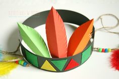 an origami crown with feathers and beads