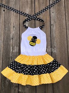 This cute custom boutique bumble bee dress would be perfect to wear for your baby girl's bumble bee theme birthday party. Dress is nice and comfy halter style black and yellow polka with a bumble bee applique on front. Your baby girl will love showing off her bumble bee dress on her special day. Bee Theme Birthday Party, Bumble Bee Dress, Bumble Bee Theme, Bee Outfit, Kidcore Fashion, Bee Applique, Bee Birthday Theme, Bug Clothing, Ladybug Girl