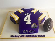 a cake shaped like a football jersey with the number four on it and a football next to it