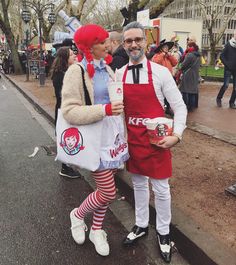 two people dressed in costumes standing next to each other