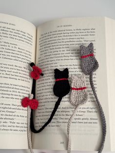 three crocheted mice are on top of an open book