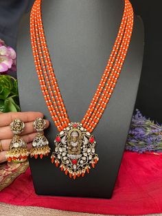 Goddess Lakshmi Pendant Coral Beads Haram with Earrings/Victorian Mehandhi Finish Orange Coral AD Haram/34.5 Inches Long/Indian Jewelry DETAILS: Includes:  One Long Haram and Two Earrings. Necklace: 22.8inches.Adjustable length. Chain Closure. Weighs 2.15oz (62g).  Earrings: 2.1 inch(es) long.  Width : one inches Earring set  weighs 1.005 Oz ( 29 g). Earring backs  Screw to on/off. Material: Imitation, Victorian  mehndhi Polish pearls,  Finish: Victorian polish Long Haram with Earrings.  NOTE: I Luxury Red Temple Necklace For Festivals, Orange Jewelry For Diwali Puja, Traditional Orange Jewelry With Silver Beads, Traditional Orange Beads For Festive Occasions, Traditional Orange Jewelry For Diwali, Traditional Orange Jewelry For Celebration, Orange Festive Jewelry For Celebration, Festive Orange Jewelry For Celebration, Orange Festive Celebration Jewelry