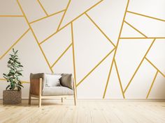 a living room with a chair, potted plant and wallpaper