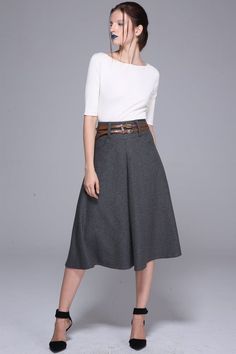 Chic Flowy Wool Skirt, Chic Wide Leg Winter Skirt, Elegant Wool Pleated Skirt For Work, Chic Wool Flared Skirt, Elegant Wool Pleated Skirt With Lining, Office Wool Flared Skirt, Elegant Winter Pleated Skirt For Work, Wool Pleated Office Skirt, Winter Workwear Pleated Midi Skirt