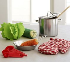 vegetables and utensils are sitting on the counter