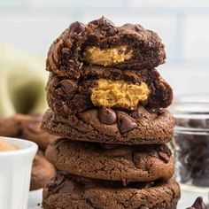 a stack of chocolate cookies with peanut butter in the middle