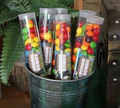 a bucket filled with lots of candy sitting on top of a table